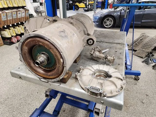 An electric vehicle drive unit removed from the vehicle and opened for service