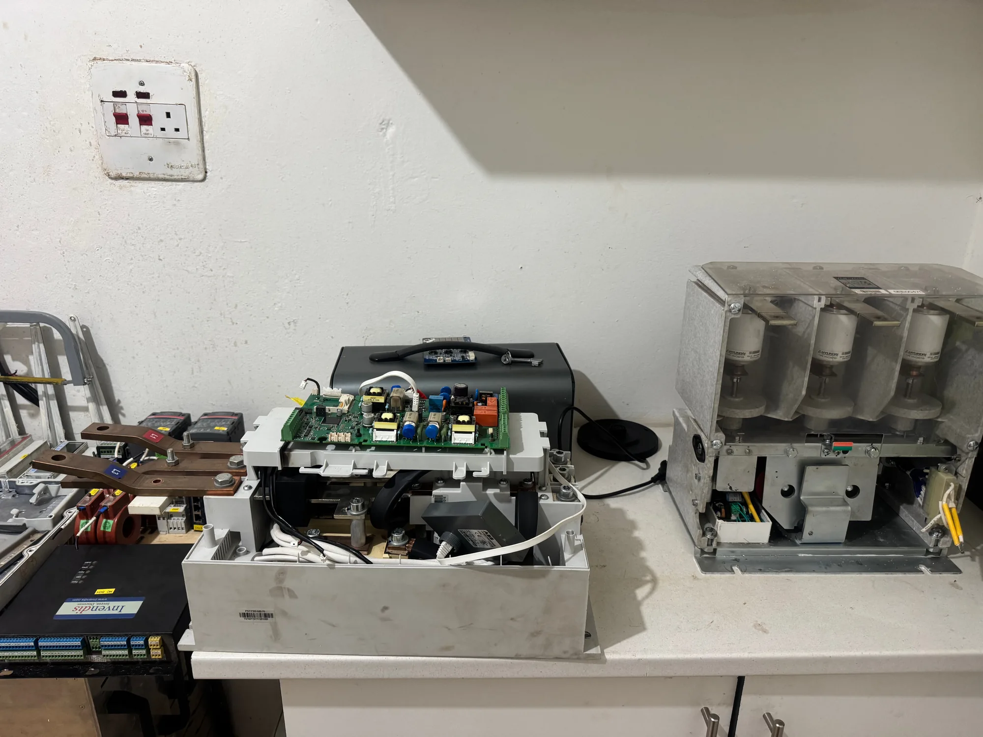 Bench instruments beside industrial power units under repair