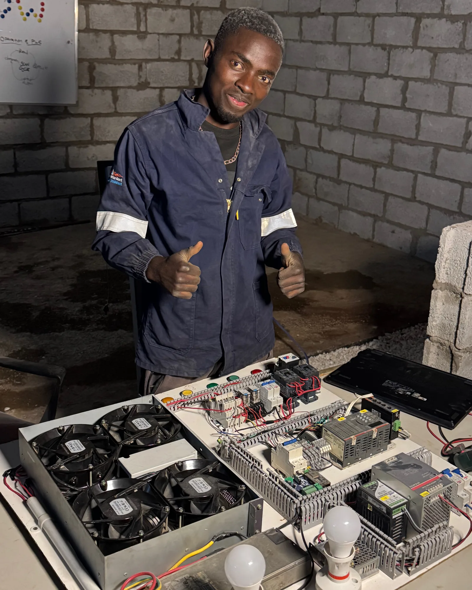 Technician behind a bench-built PLC control panel
