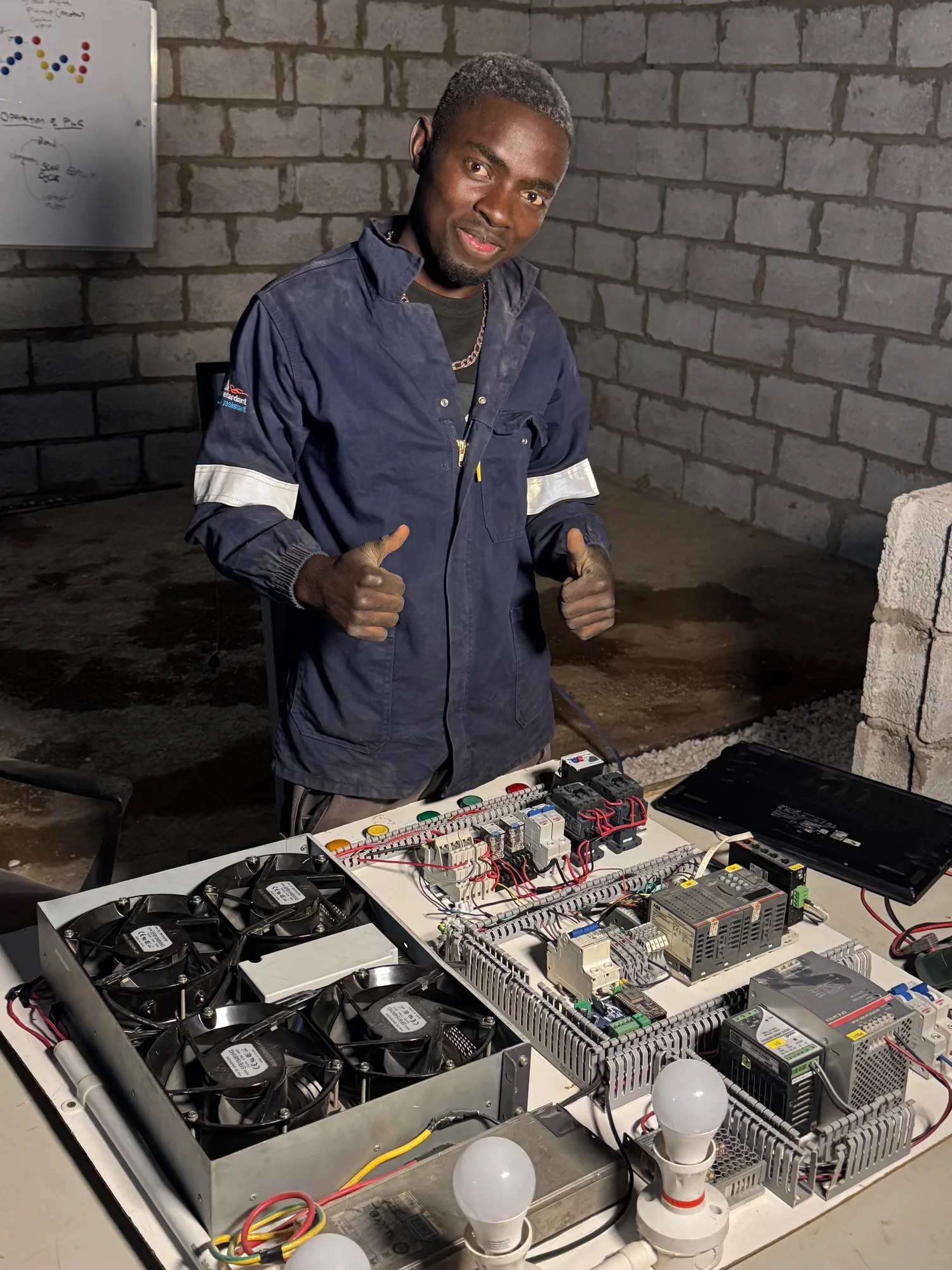 Technician behind a bench-built PLC panel