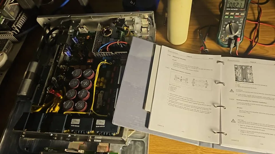 Technician inspecting a dishwasher control board with a digital multimeter