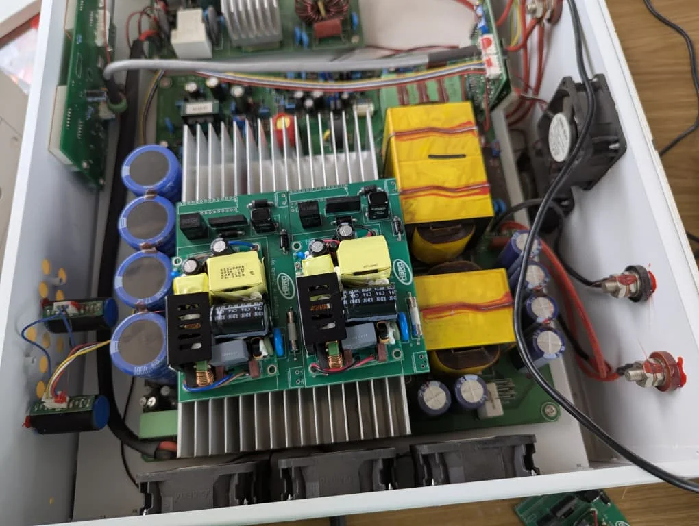 Two HCS contactor-economiser control units (SCU) fitted inside an open soft starter, among heatsinks, capacitors, transformers and cooling fans